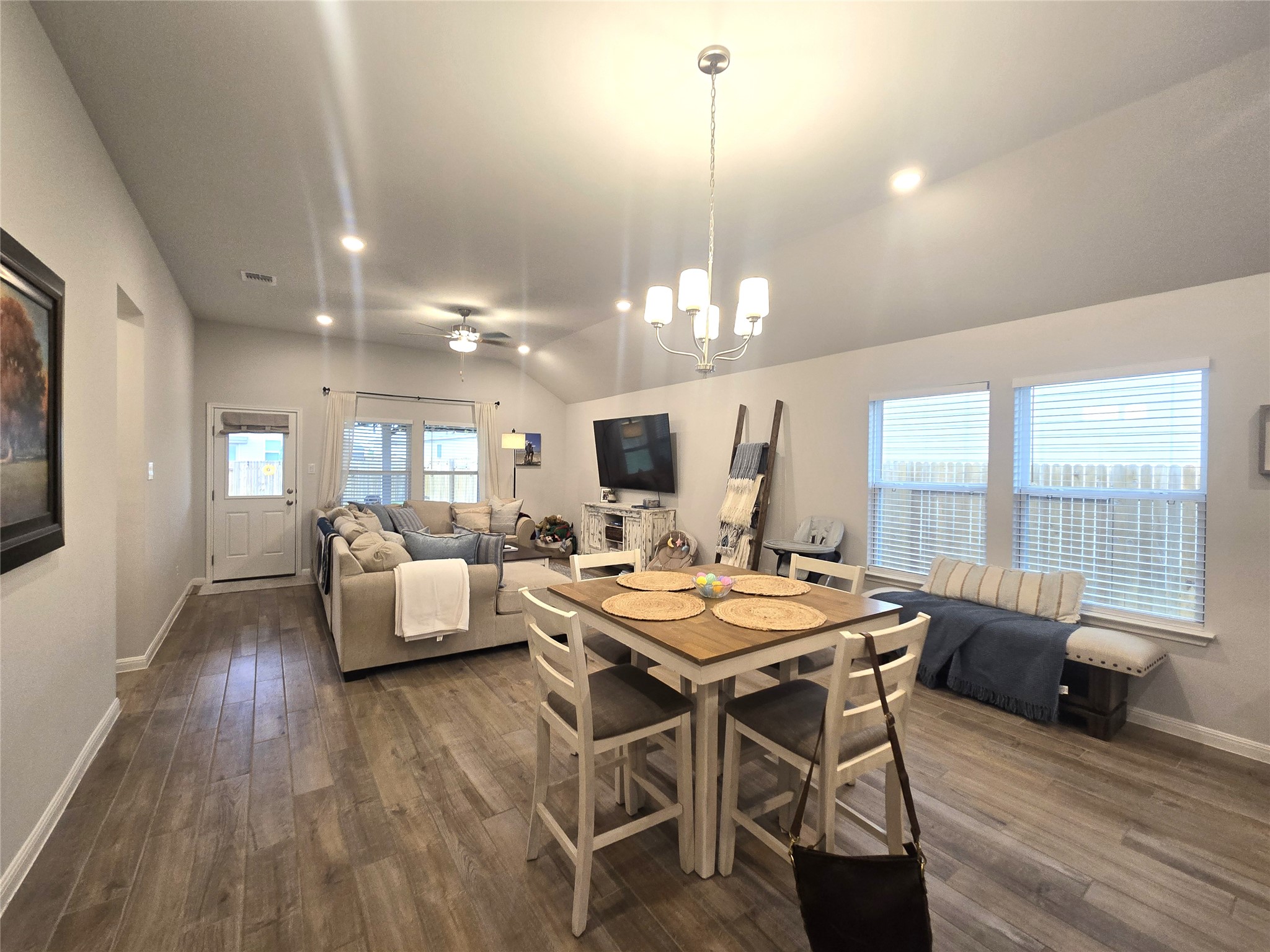 133 Boulder Ridge Trail Liberty Hill, TX 78642 - Photo 8 of 32 Dining room with a chandelier, a ceiling fan, dark wood-style flooring, and lofted ceiling