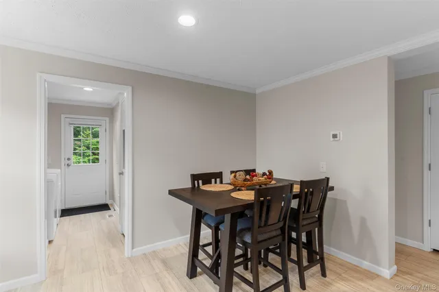 a view of a dining room with furniture and window