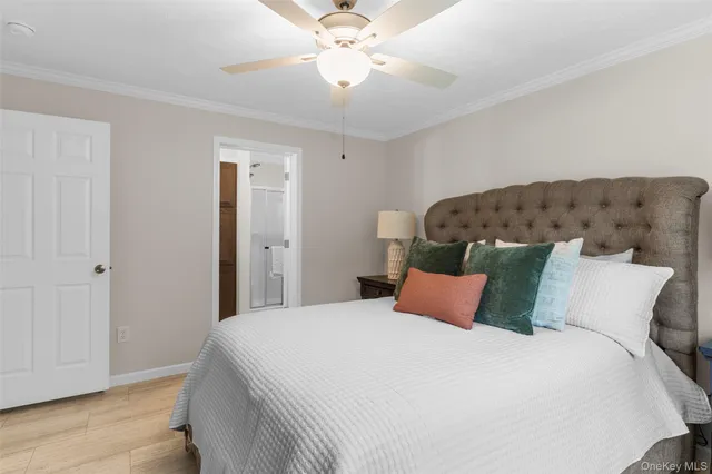 a bedroom with a bed and a ceiling fan