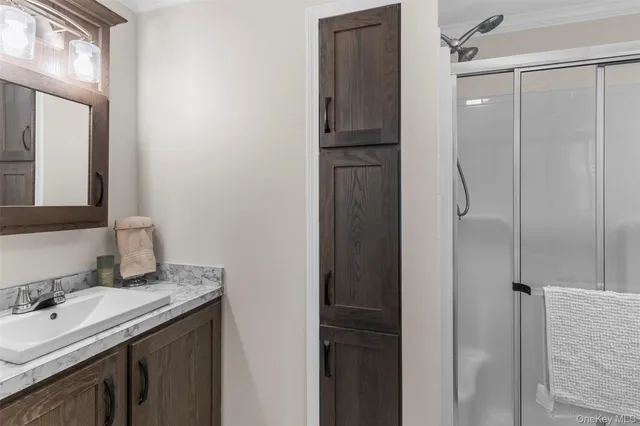 a bathroom with a granite countertop sink vanity and mirror