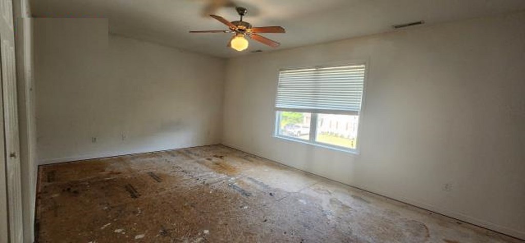 2402 Octopus Road Greenbackville, VA 23356 - Photo 9 of 21 an empty room with windows and fan