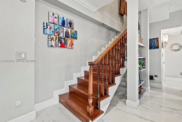 a view of entryway with lots of frames and a painting on the wall