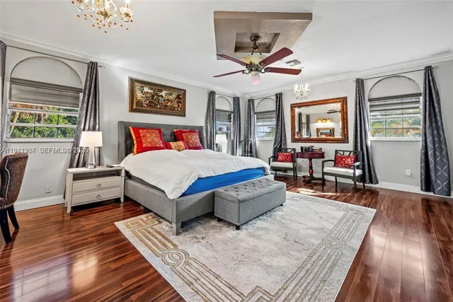 a living room with a bed furniture and a large window