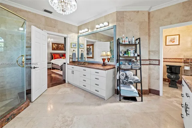 a bedroom with a balcony a bed and a chandelier