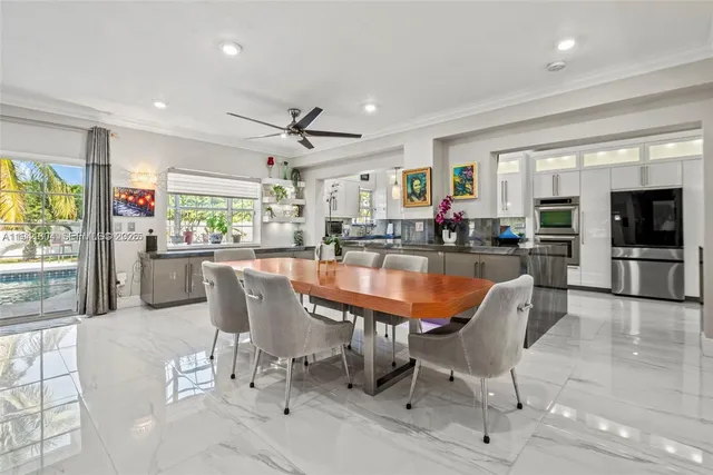 a dining room with furniture a window and a kitchen