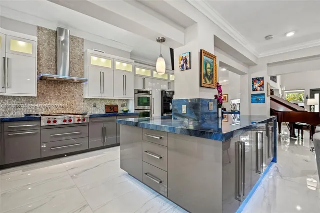 a kitchen with stainless steel appliances granite countertop a stove and cabinets