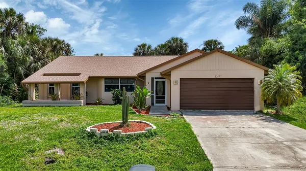 a front view of a house with a yard and garage