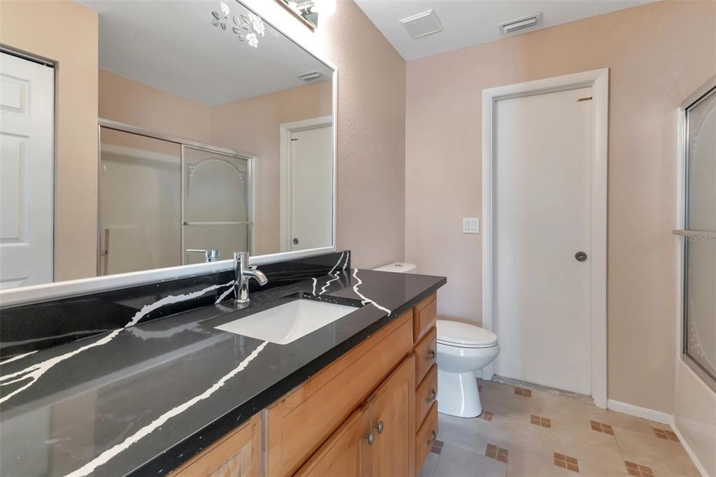 23177 Rye Avenue Punta Gorda, FL 33980 - Photo 16 of 48 a bathroom with a sink a toilet a mirror and shower