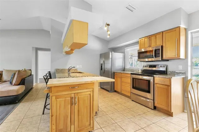 a kitchen with a stove a sink and a microwave