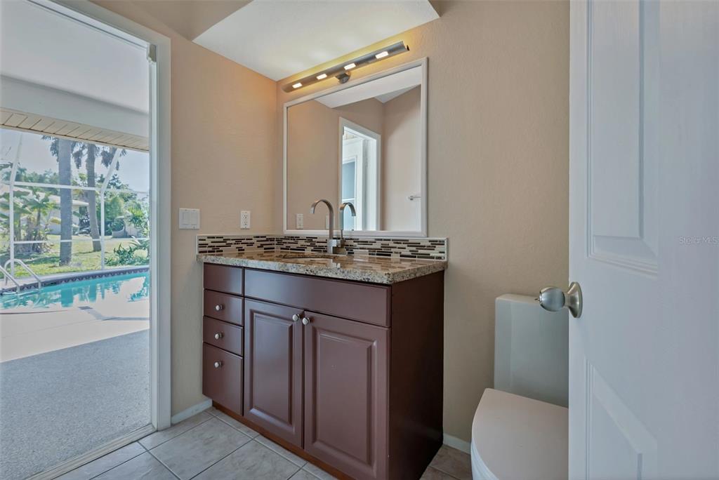 23177 Rye Avenue Punta Gorda, FL 33980 - Photo 23 of 48 a bathroom with a sink a toilet and mirror