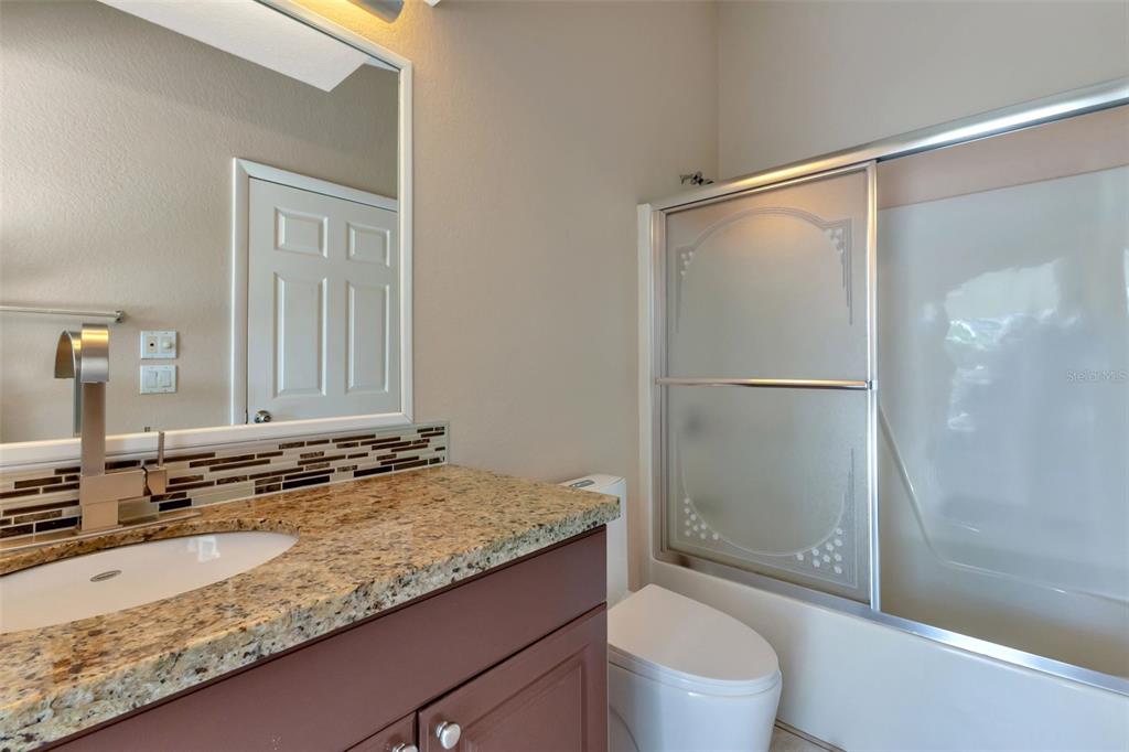 23177 Rye Avenue Punta Gorda, FL 33980 - Photo 24 of 48 a bathroom with a granite countertop sink toilet and shower