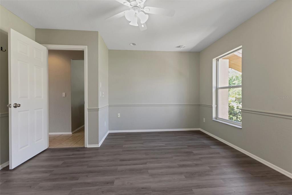 23177 Rye Avenue Punta Gorda, FL 33980 - Photo 29 of 48 an empty room with wooden floor cabinet and windows