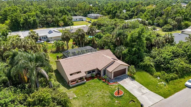 an aerial view of a house with swimming pool and garden