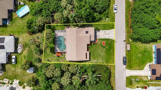 a view of a house with a street sign and a yard