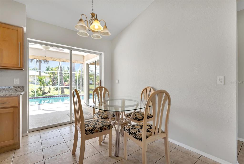 23177 Rye Avenue Punta Gorda, FL 33980 - Photo 10 of 48 a dining room with furniture and a chandelier