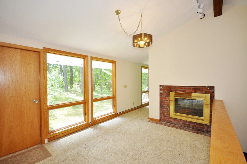136 Temple Road Concord, MA 01742 - Photo 2 of 27 a view of an empty room with a window and kitchen view