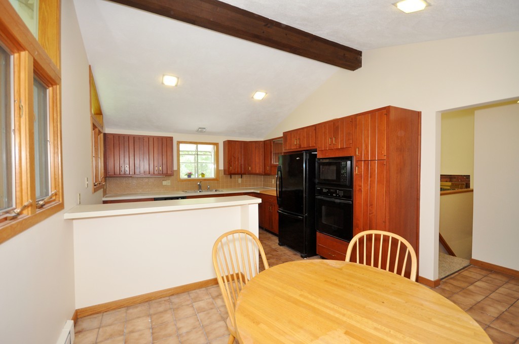 136 Temple Road Concord, MA 01742 - Photo 7 of 27 a kitchen with stainless steel appliances a refrigerator and a stove top oven
