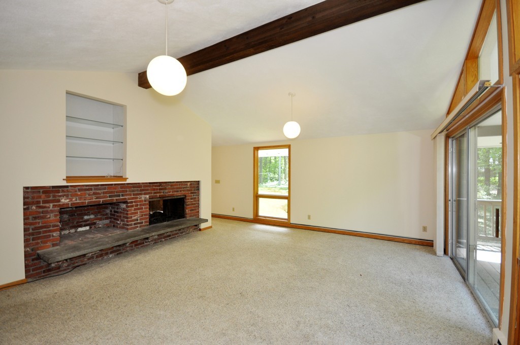 136 Temple Road Concord, MA 01742 - Photo 9 of 27 a view of an empty room with wooden floor and a window