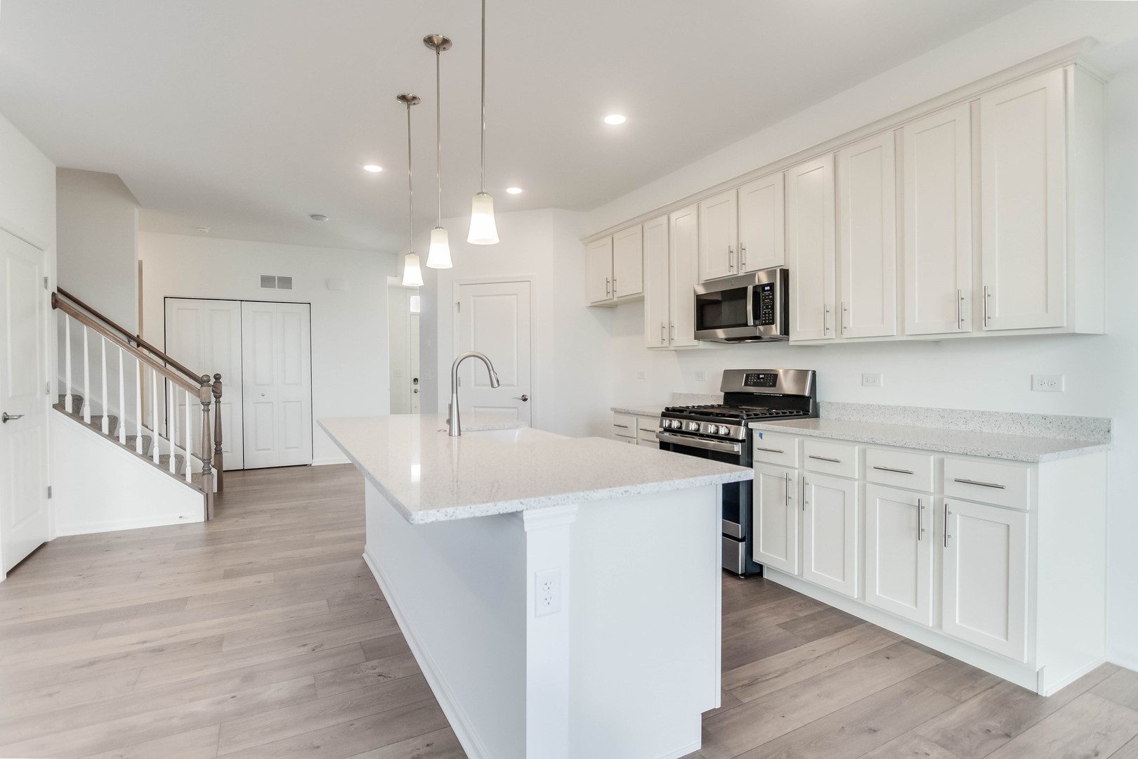 25501 West Emory Lane Plainfield, IL 60544 - Photo 11 of 28 a kitchen with stainless steel appliances granite countertop a sink stove and microwave