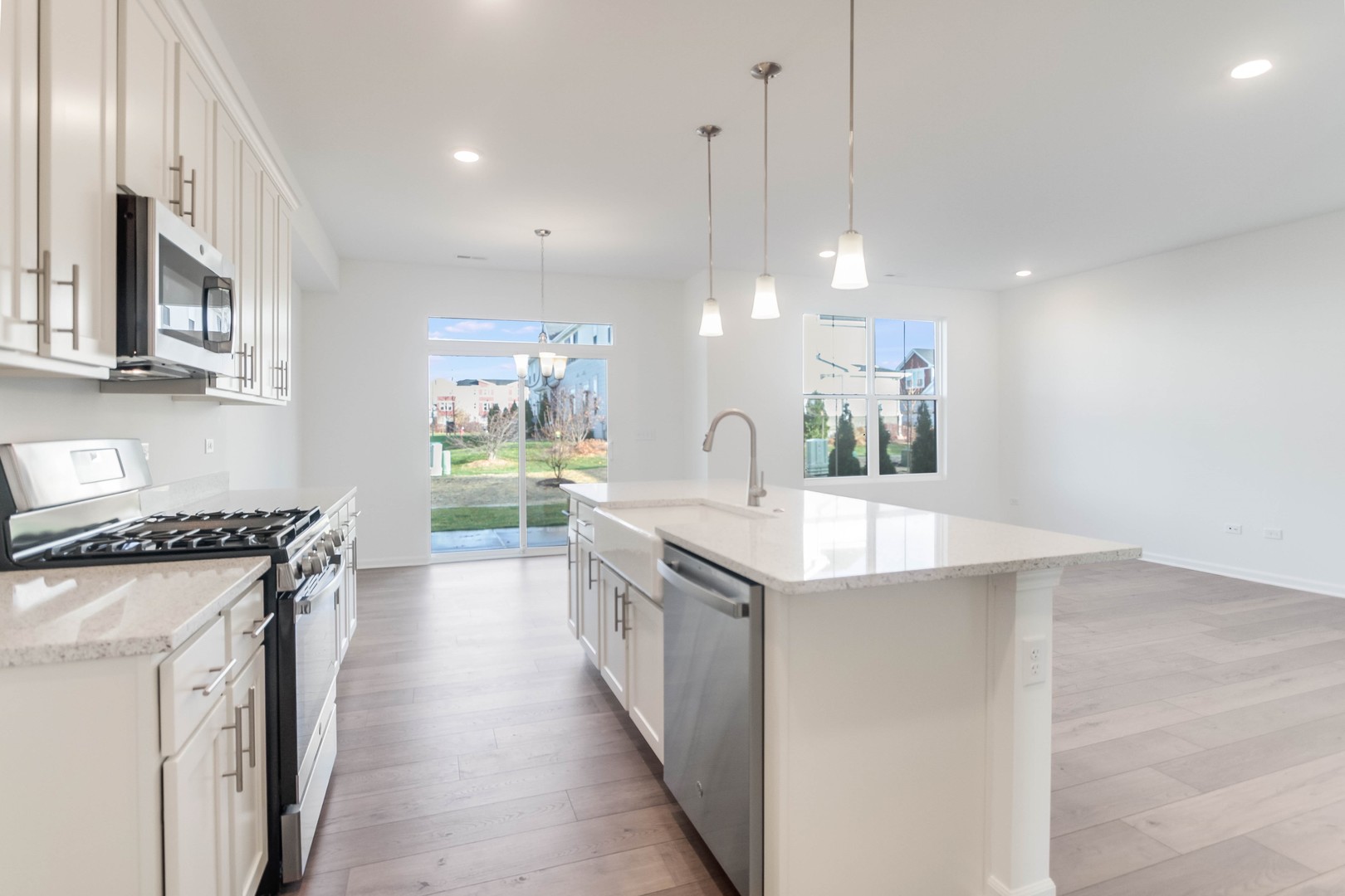 25501 West Emory Lane Plainfield, IL 60544 - Photo 14 of 28 a kitchen with stainless steel appliances granite countertop a sink a stove and a wooden floors