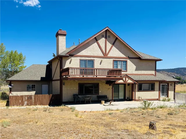 a living room with fireplace furniture and a large window