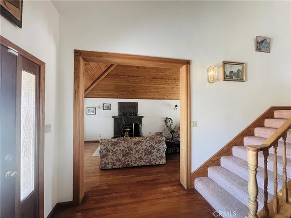 a spacious bedroom with a bed and a chandelier