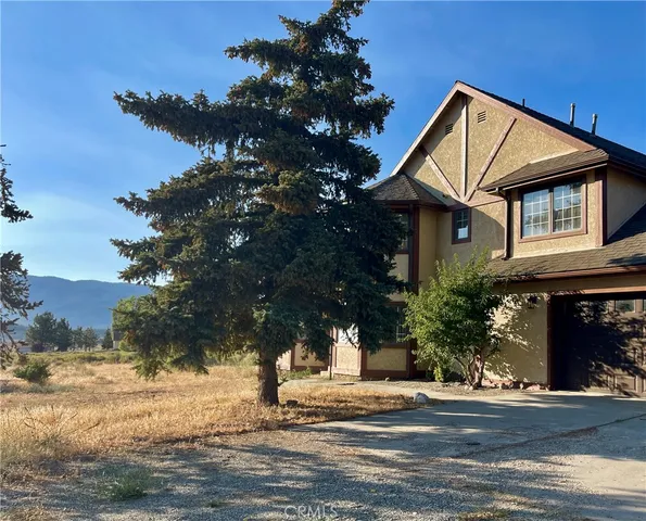 a view of a house with a tree