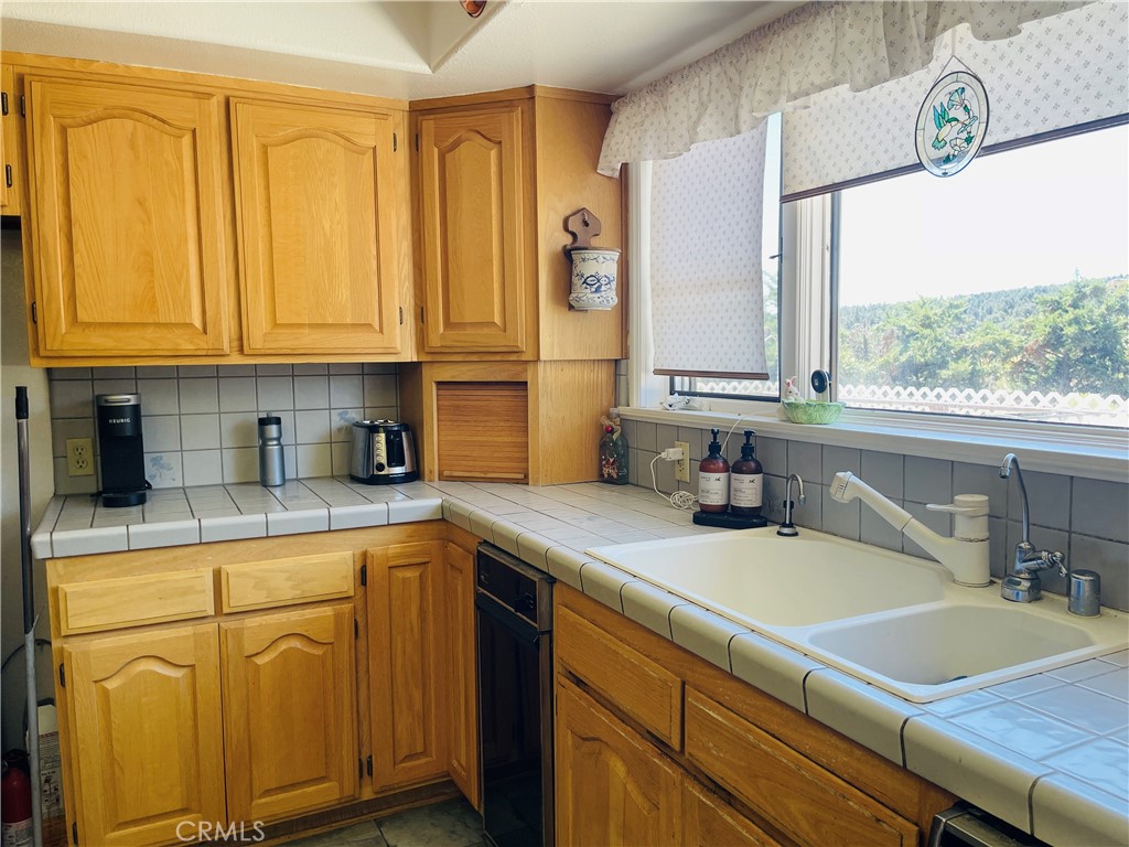 10500 Steinhoff Road Frazier Park, CA 93225 - Photo 34 of 75 a kitchen with stainless steel appliances granite countertop a sink a stove and cabinets