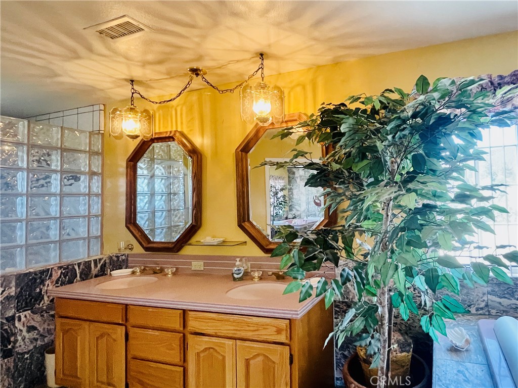 10500 Steinhoff Road Frazier Park, CA 93225 - Photo 41 of 75 a bathroom with a sink and mirror with painted walls