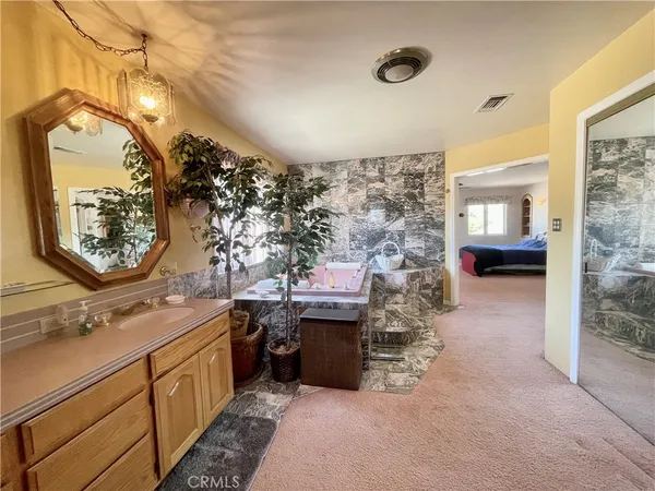 a view of a livingroom with a ceiling fan and window