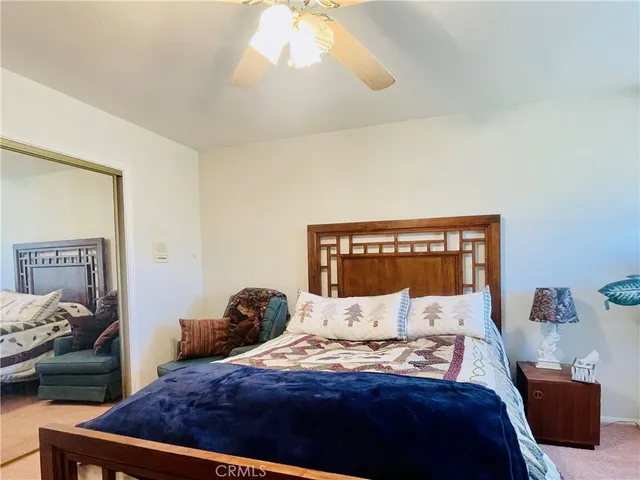 a view of a livingroom with a ceiling fan and window