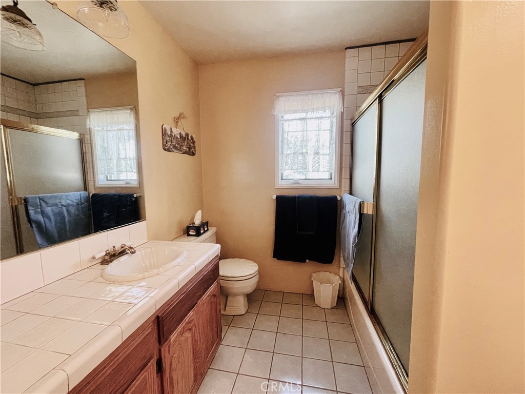 10500 Steinhoff Road Frazier Park, CA 93225 - Photo 50 of 75 a bathroom with a sink a toilet and mirror
