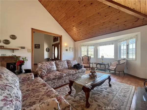 a living room with furniture a flat screen tv and a table