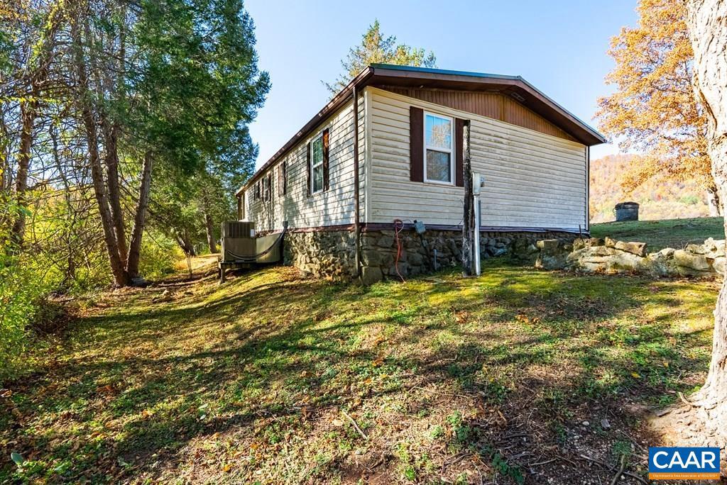 1066 Stevens Cove Road Lovingston, VA 22949 - Photo 25 of 34 a front view of a house with a yard