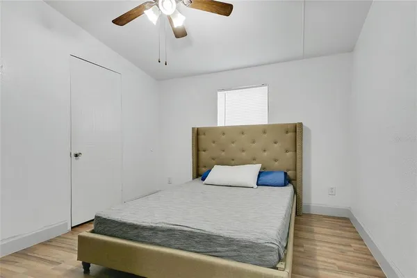 a bedroom with a bed and a window