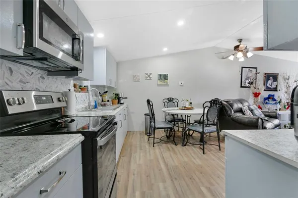 a view of a kitchen with sink and cabinets
