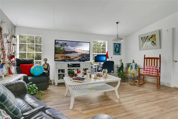 a living room with fireplace furniture and a flat screen tv