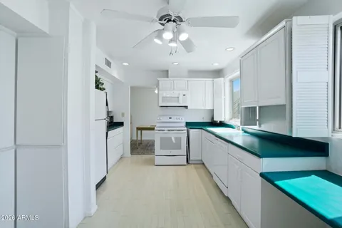 a kitchen with stainless steel appliances white cabinets and window