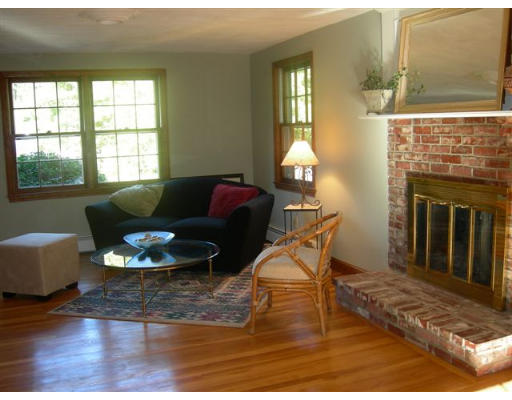 89 Ortins Road Hamilton, MA 01982 - Photo 5 of 8 a living room with furniture and a fireplace