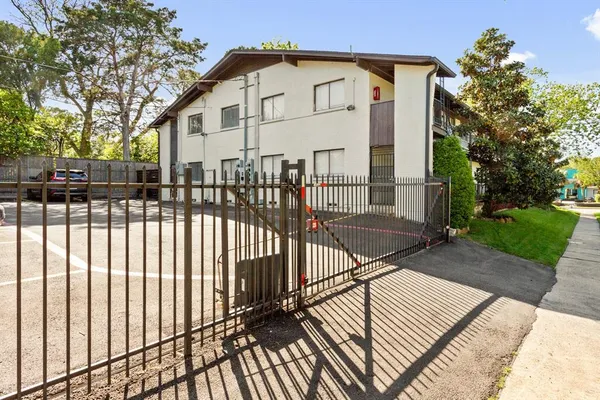 a view of a white building that has a white roof