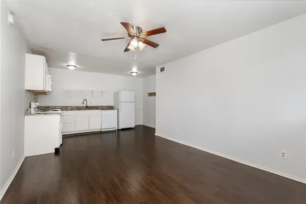 a view of a kitchen with a sink and microwave