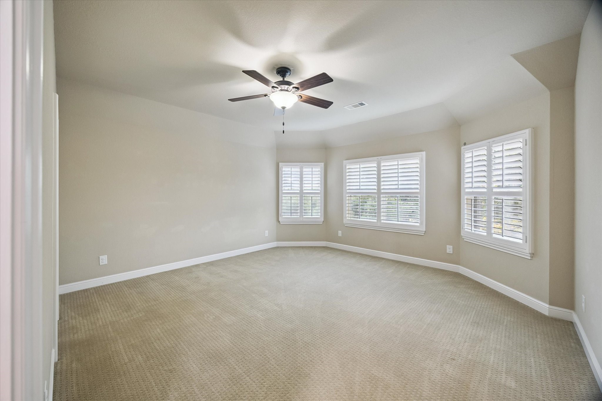 35 North Fremont Ridge Loop Spring, TX 77389 - Photo 26 of 37 This generously sized secondary bedroom showcases elegant plantation shutters, abundant natural light, and a comfortable layout. A bright and welcoming space that can easily accommodate family, guests, or a personalized retreat.