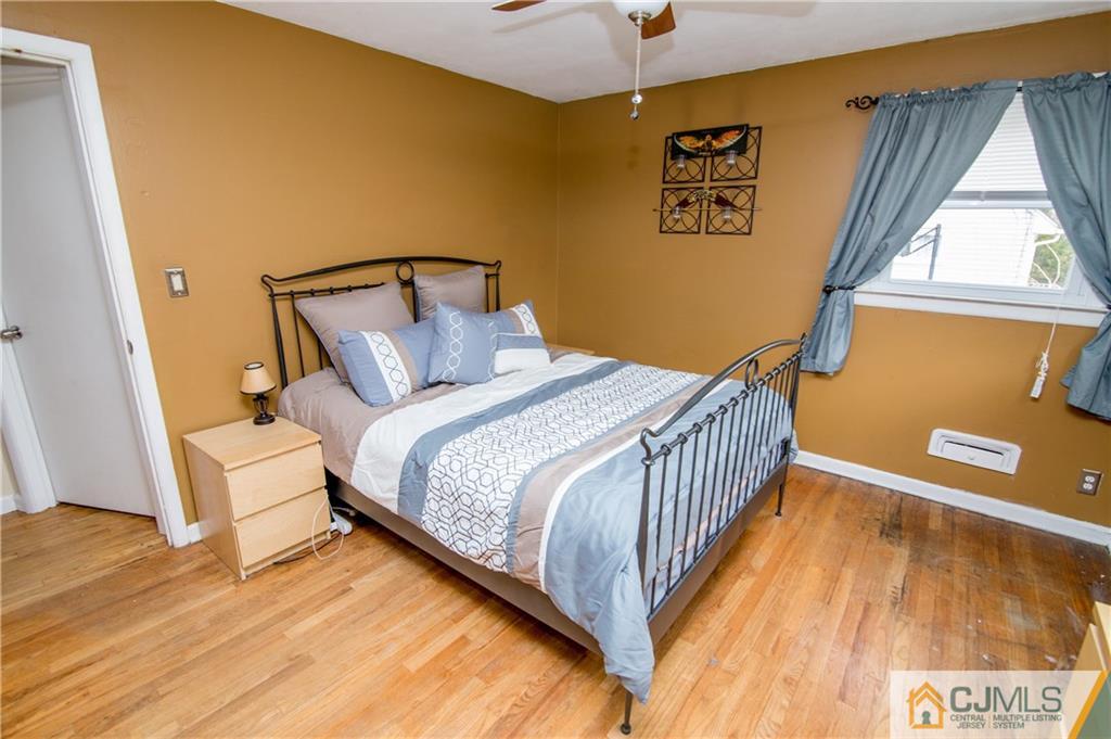 20 North Pennington Road New Brunswick, NJ 08901 - Photo 14 of 25 a bedroom with a bed and wooden floor