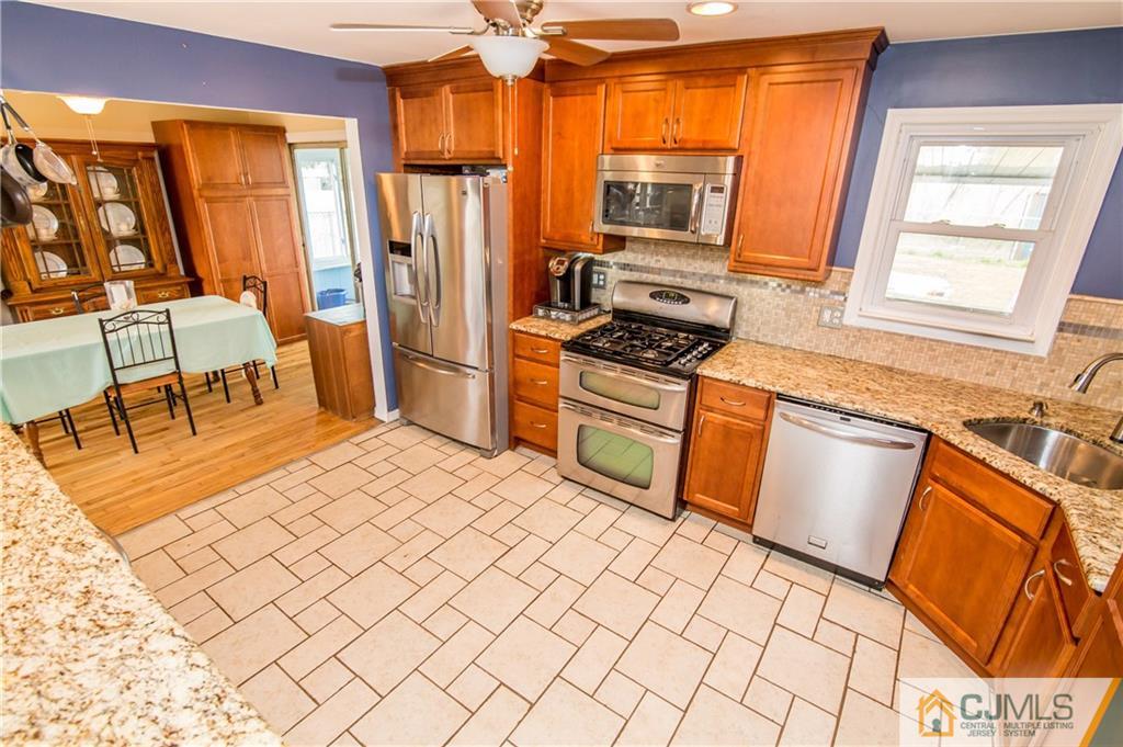 20 North Pennington Road New Brunswick, NJ 08901 - Photo 3 of 25 a kitchen with stainless steel appliances a stove refrigerator sink and chair