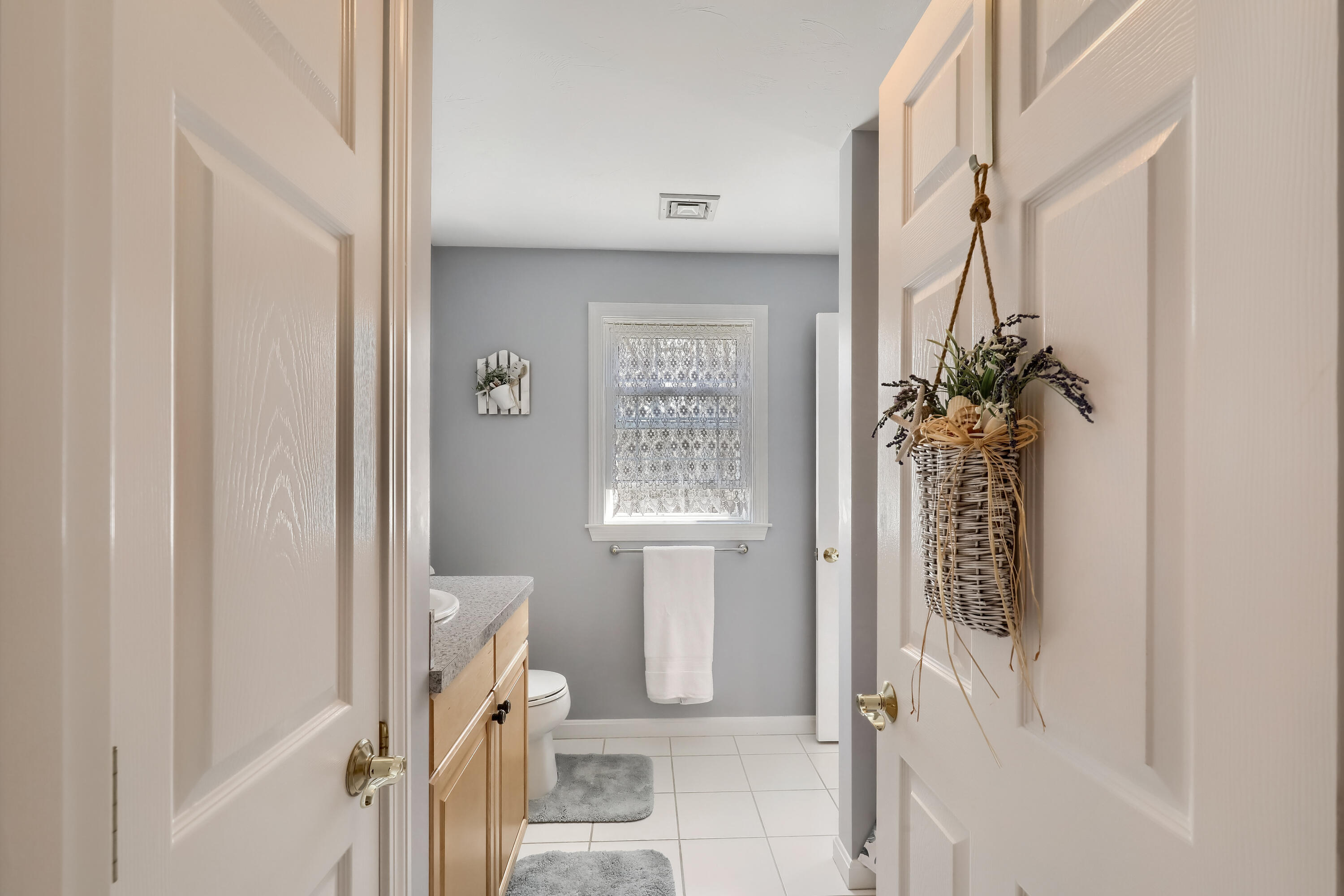 57 Fox Hill Road Mashpee, MA 02649 - Photo 16 of 23 a view of a hallway with a white walls and a bathroom next to a window