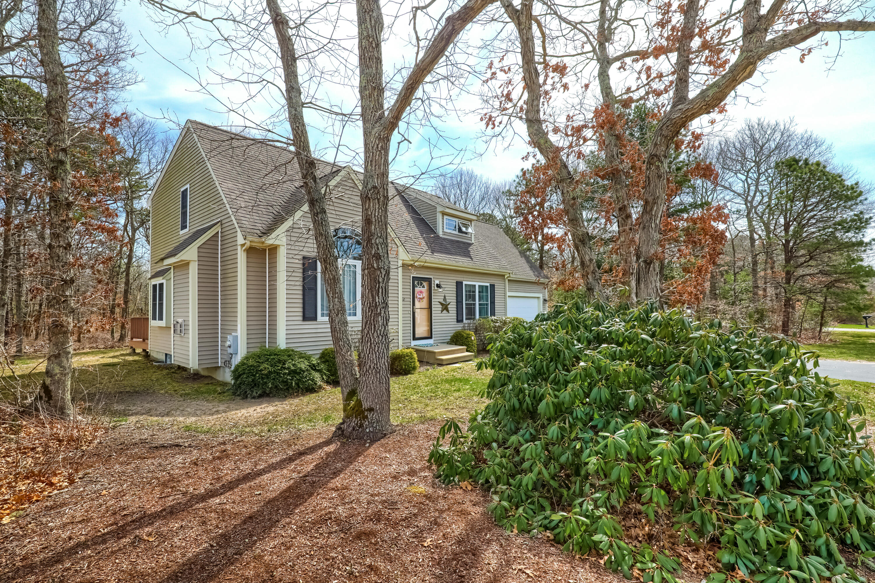 57 Fox Hill Road Mashpee, MA 02649 - Photo 2 of 23 a front view of a house with garden