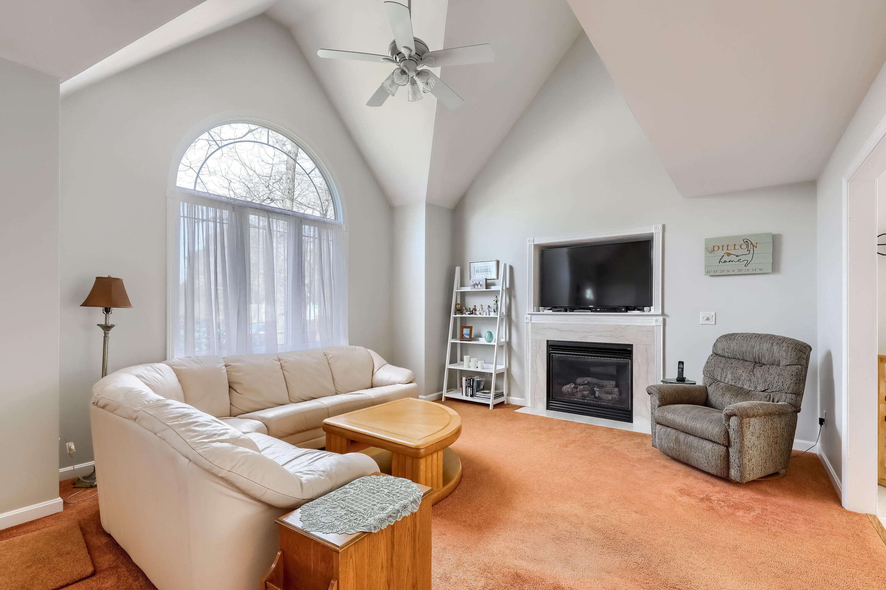 57 Fox Hill Road Mashpee, MA 02649 - Photo 4 of 23 a living room with furniture a fireplace and a flat screen tv