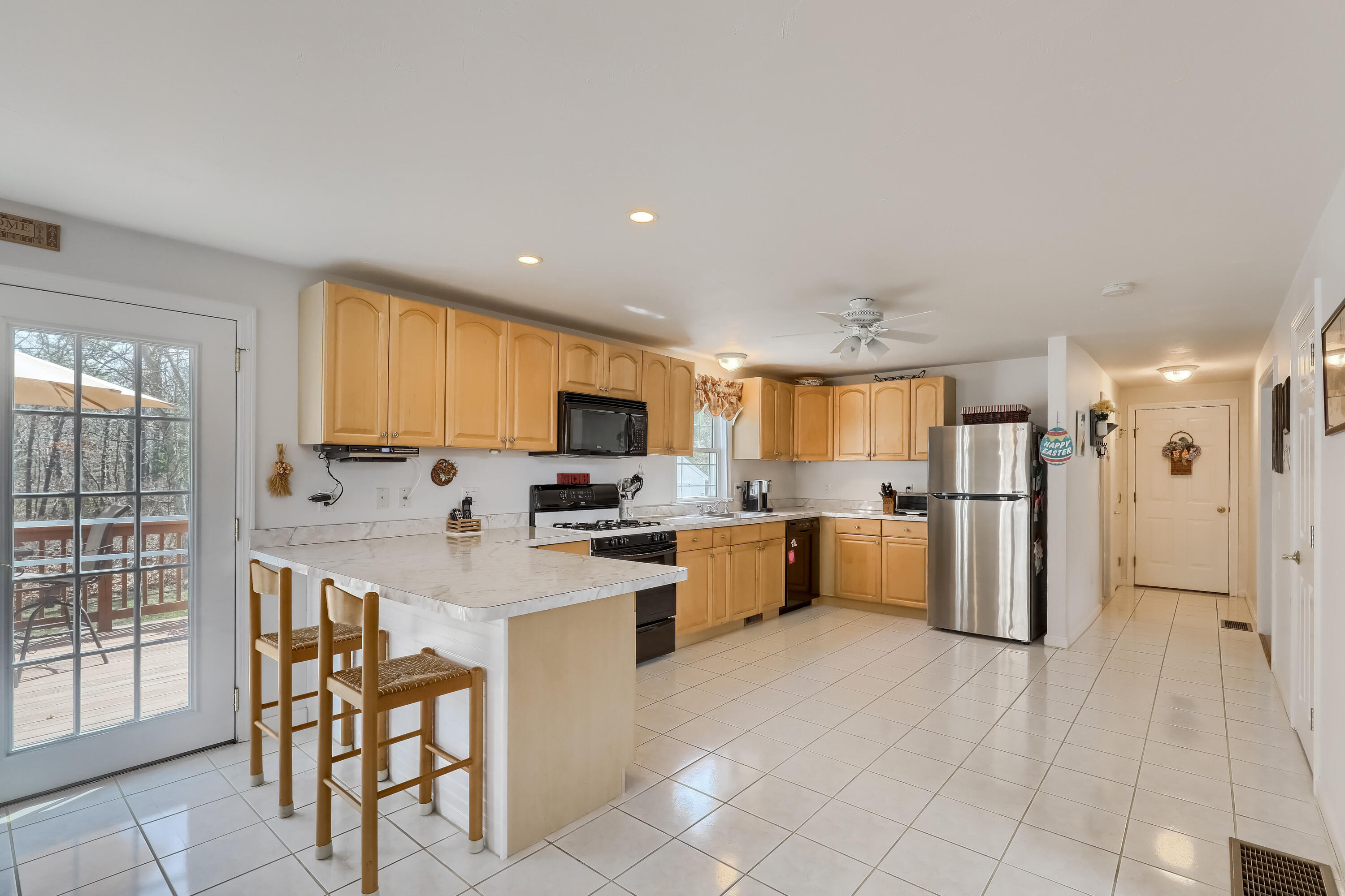 57 Fox Hill Road Mashpee, MA 02649 - Photo 6 of 23 a kitchen with stainless steel appliances kitchen island granite countertop a refrigerator and cabinets