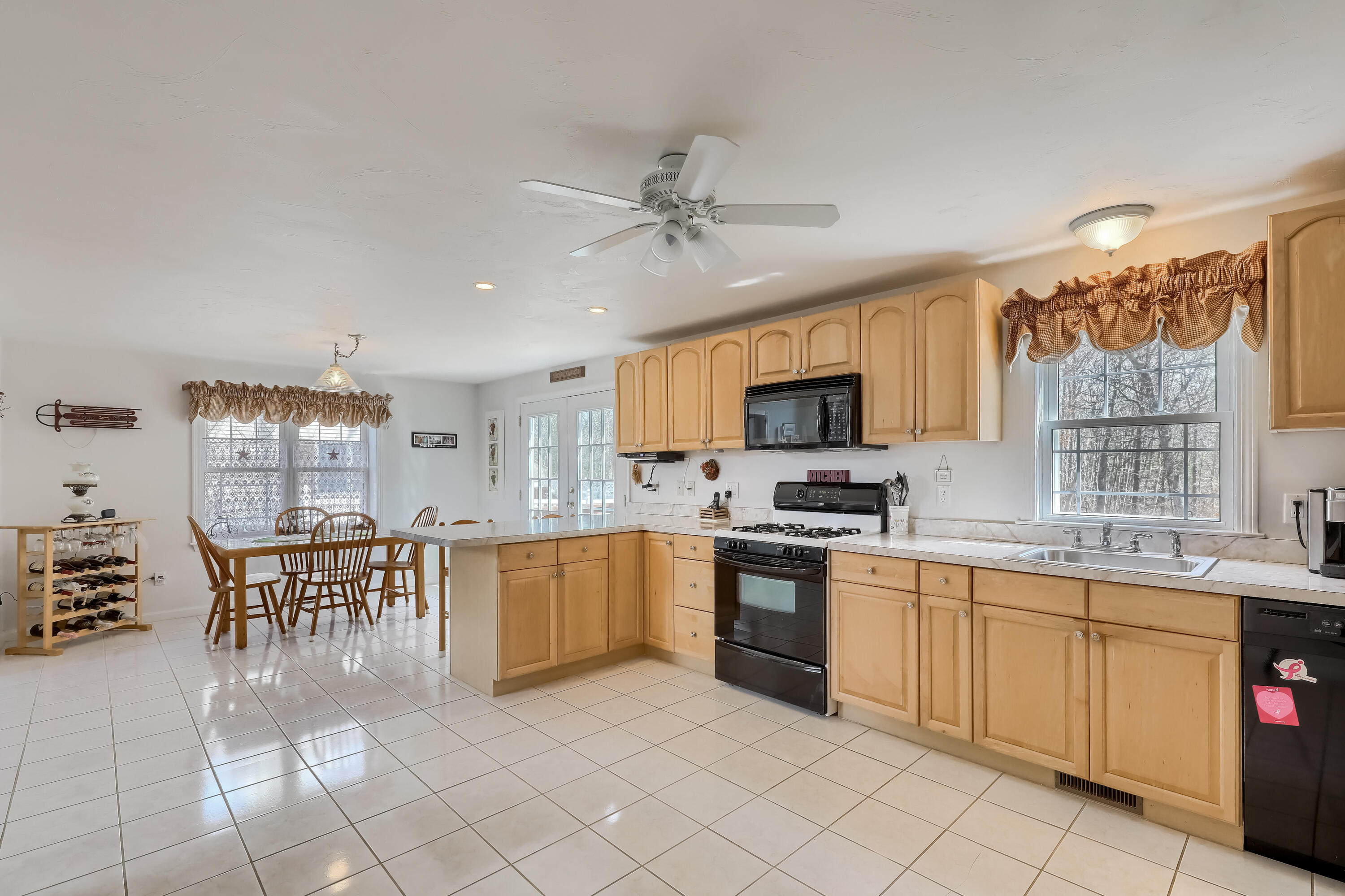 57 Fox Hill Road Mashpee, MA 02649 - Photo 7 of 23 a kitchen with stainless steel appliances granite countertop a stove top oven a sink a dining table and chairs