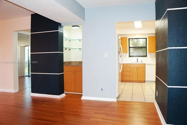 a view of a refrigerator in kitchen and wooden floor